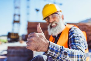 Man in a Hi Vis jacket, smiling and putting his thumb up